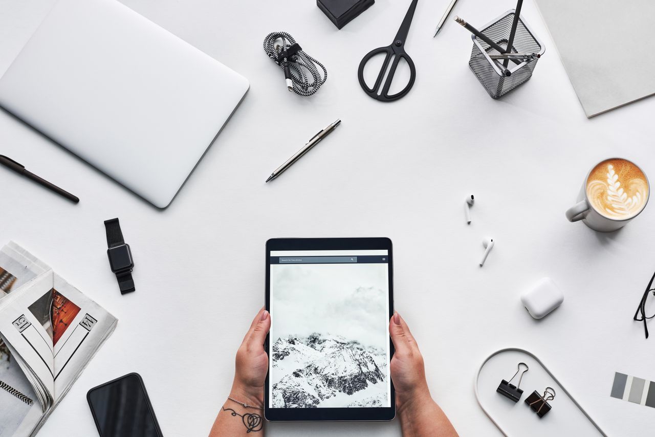 gallery-01 Flat lay of a modern workspace featuring a tablet, gadgets, and coffee for creative work.